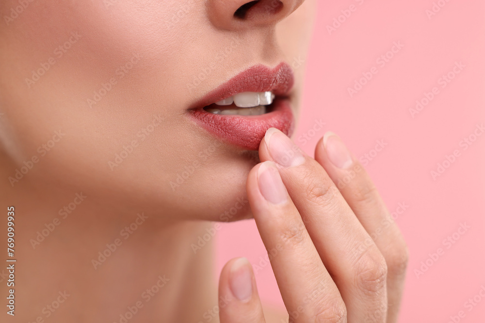 Woman with beautiful lips on pink background, closeup Woman with beautiful lips on pink background, closeup