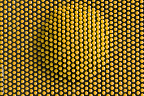 Lots of yellow spherical details on dark. Volumetric balloon. Abstract background or backdrop. Concept of the connection of many identical elements in a matrix. Photo
