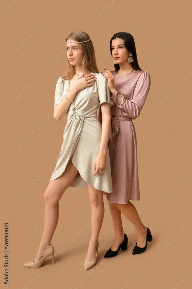 Beautiful young women with different stylish jewelry on brown background Beautiful young women with different stylish jewelry on brown background