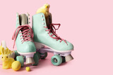Vintage roller skates with Easter eggs, toy bunny and chick on pink background