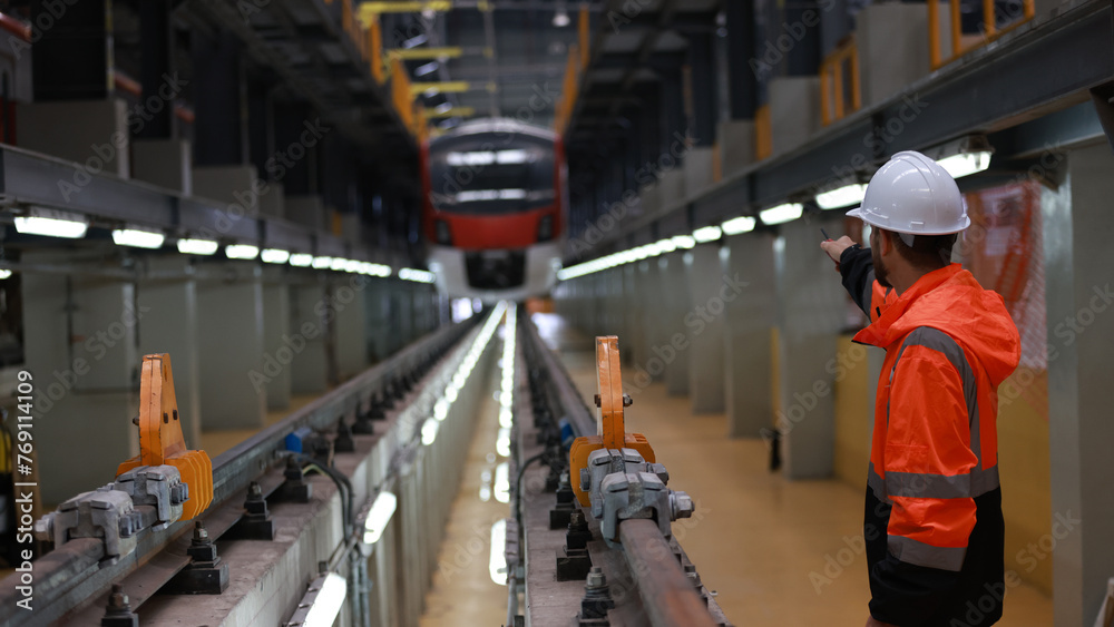 Observing the engineer working on the Electrical train tracks. Observing the engineer working on the Electrical train tracks.