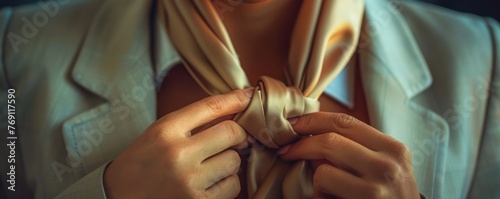 Close-up of a businesswoman s hands gently unwrapping silk ties photo