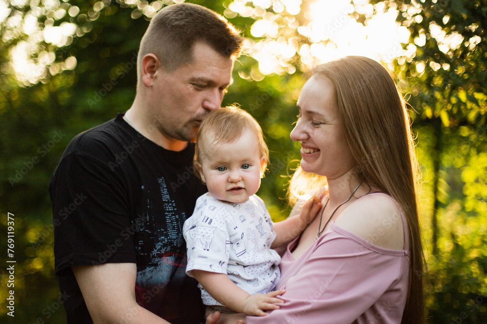 A happy family in the sunset rays in summer A happy family in the sunset rays in summer