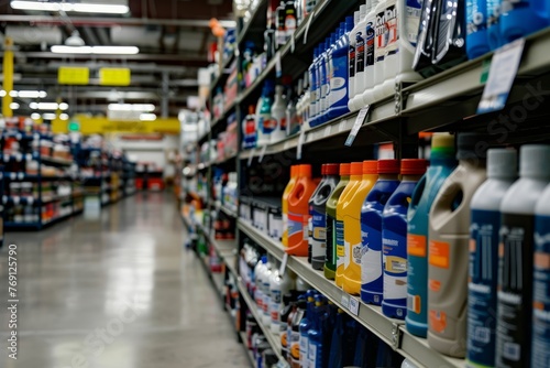 A store aisle lined with shelves stocked with numerous bottles of different cleaner products