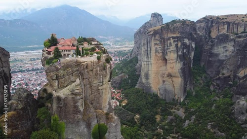 Aerial view of Monastery of the Holy Trinity (Agia Triada) in Meteora, Greece with Kalabaka town and mountains in the background