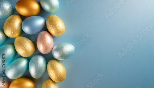 colorful plastic easter eggs lined up on the left hand side of a blue background and copy space ester background photo