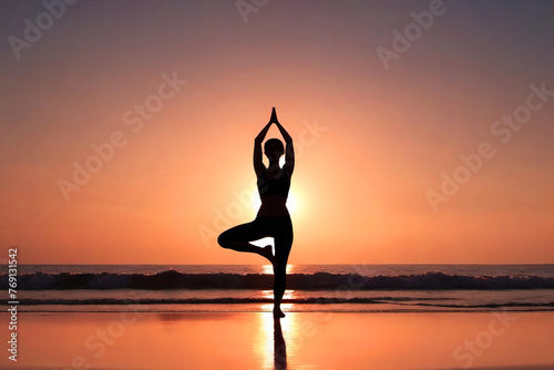 Silhouette of a woman practicing yoga on the beach at sunset. Healthy lifestyle concept, poster, banner, copy space. © Plutmaverick