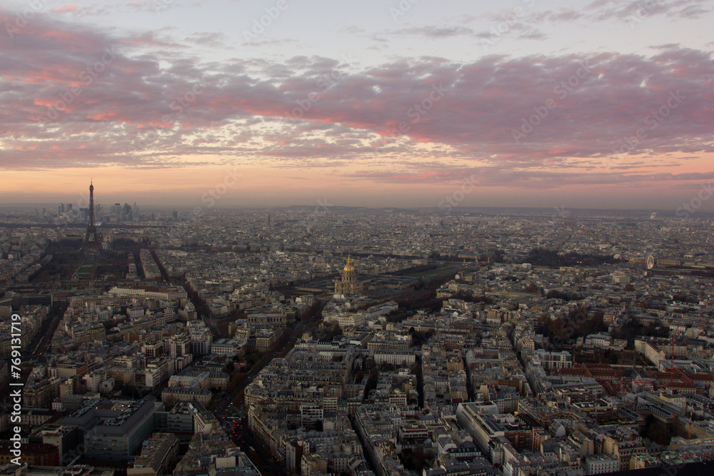 Aerial view, from Montparnasse tower at sunset and night sky, view of the Eiffel Tower and La Defense district in Paris, France