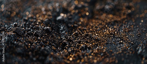 An intricate and detailed close-up view of a surface with a blend of black and gold textures, creating a visually appealing pattern