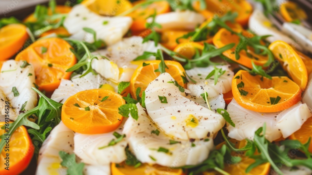 a close up of a plate of food with oranges and scallops on it with a fork on the side. a close up of a plate of food with oranges and scallops on it with a fork on the side.