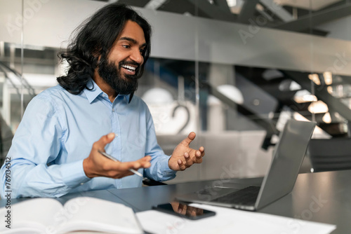 Happy businessman using laptop