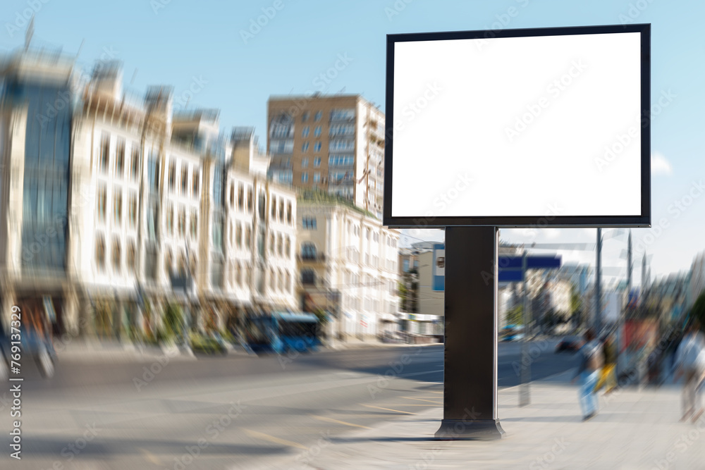 Empty billboard in the urban environment on the sidewalk with the townspeople. Mock-up.