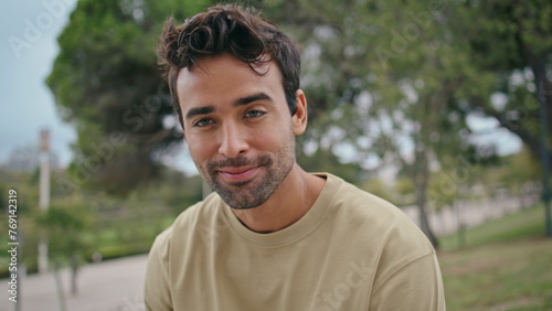 Portrait handsome hipster park greenery. Positive unshaven man looking camera