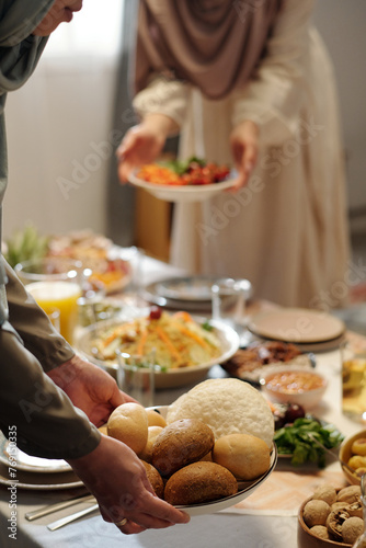 Unrecognizable Muslim Women Setting Table On Uraza Bayram photo