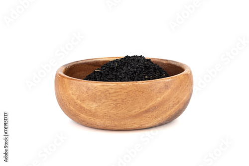 Black sesame in wooden bowl on white background. © svdolgov