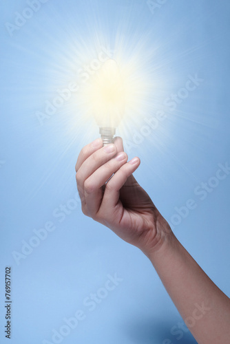 Hand Holding a Glowing Lamp: Illuminating Ideas