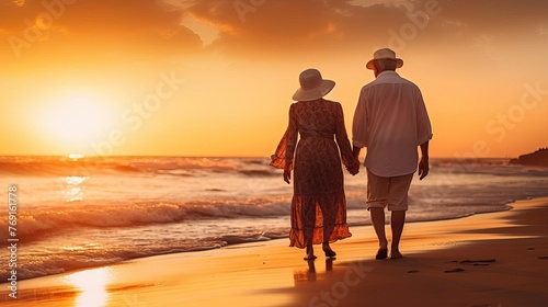 Elderly Couple Walking Along Seashore at Sunset