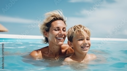Happy Mother and Son Swimming in Resort Pool