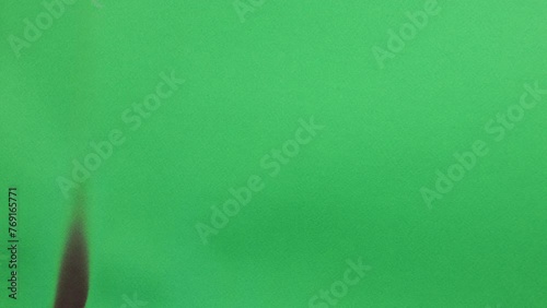 Burning green screen 4K revealing black background Easy to matte Special effect video. Green screen burning. Black behind background. Perfect nice organic transition SFX special effect easy matte