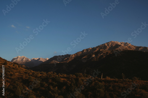 landscape with mountain peaks background the sky with clouds at sunset in autumn © alexkoral
