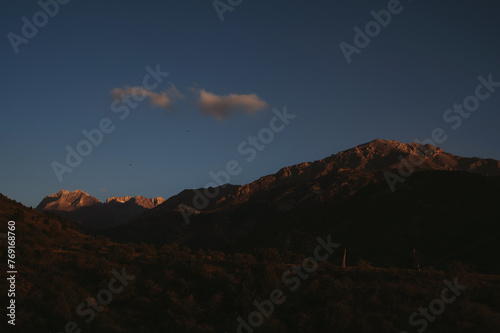 landscape with mountain peaks background the sky with clouds at sunset in autumn