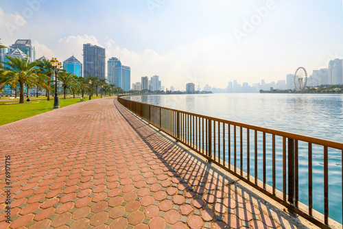 View of the modern skyline of Sharjah, United Arab Emirates from the waterfront promenade and central souk park. photo