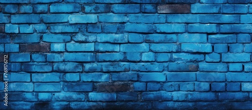 The image showcases a striking blue brick wall meticulously designed with a bold black grouting pattern in between each brick