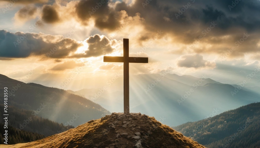 jesus christ cross easter resurrection concept christian cross on a background with dramatic lighting colorful mountain sunset dark clouds and sky and sunbeams - obrazy, fototapety, plakaty 