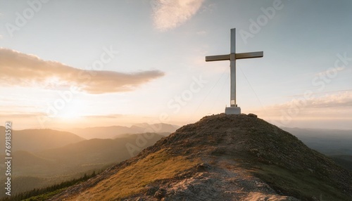 cross on top of a mountain at sunset