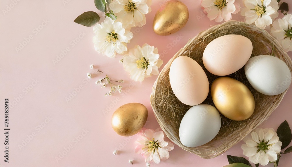 happy easter concept flat lay easter eggs on pastel pink background with flowers top view with copy space
