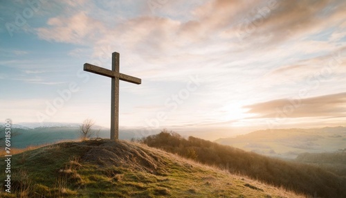 christian cross on hill outdoors at sunrise resurrection of jesus concept photo
