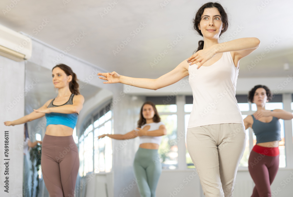 During dance lesson, girls practice and repeat memorize movements to perform slow classical waltz dance. Dance school for beginners