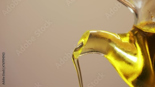 Pouring olive oil in different dishes close-up. Using in cooking for frying foods or as a salad dressing omega 3. Olive oil is popular supplement for meals and salads.  photo