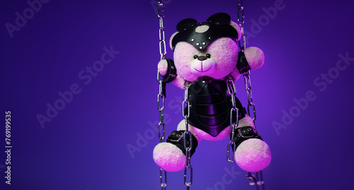 A teddy bear in a mask is suspended from chains in leather handcuffs and accessories for bdsm games and sex in neon light against a background of copy paste