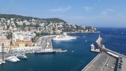 View of the port of Nice baie des anges , Colorful houses in the city of Nice on the french riviera in South East of France with a lot of boats in the harbour. photo
