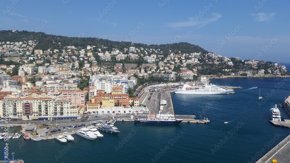 View of the port of Nice baie des anges , Colorful houses in the city of Nice on the french riviera in South East of France with a lot of boats in the harbour.