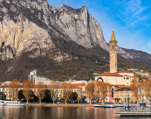 Pier and boats docked at marina on Lake Como in the harbor of the city of Lecco, Lombardy, Northern Italy