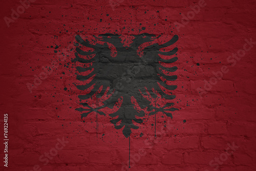 colorful painted big national flag of albania on a massive brick wall