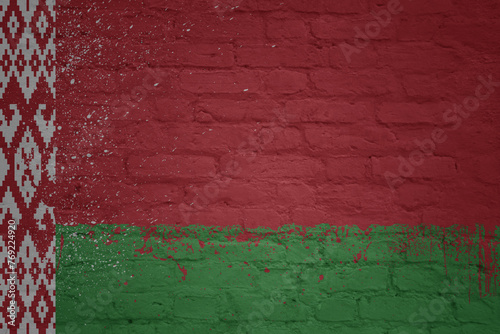 colorful painted big national flag of belarus on a massive brick wall