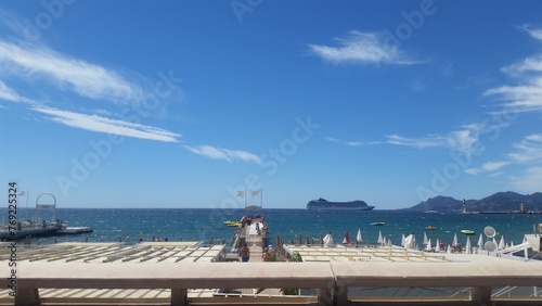 Private beach umbrellas and sea view at La Croisette, Cannes, French Riviera, summer vacation photo