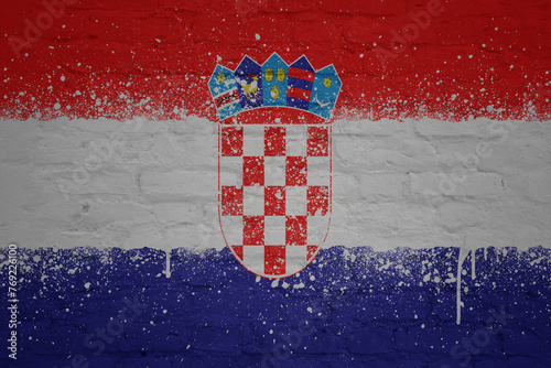 colorful painted big national flag of croatia on a massive brick wall