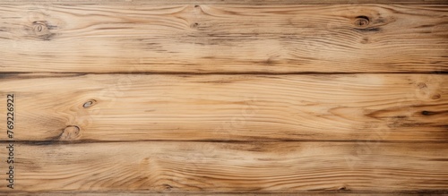 A detailed shot of a brown hardwood plank table, showcasing the natural wood grain and texture, set against a blurred beige flooring background
