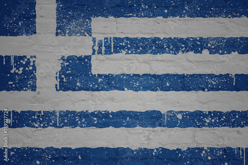 colorful painted big national flag of greece on a massive brick wall