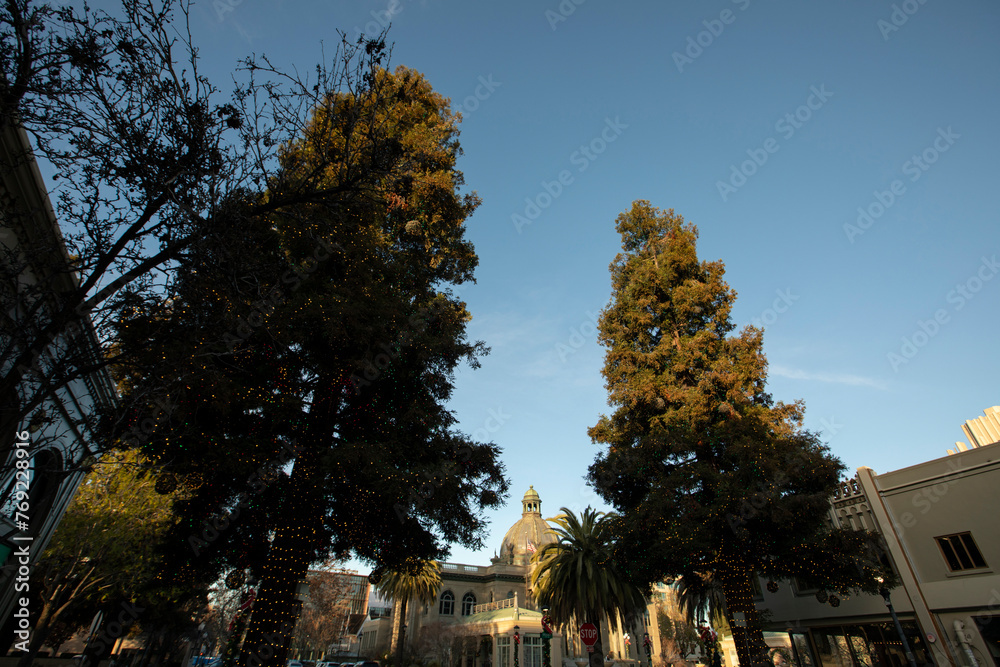 Sunlight light shines on historic downtown buildings and trees of Redwood City, California, USA. Sunlight light shines on historic downtown buildings and trees of Redwood City, California, USA.
