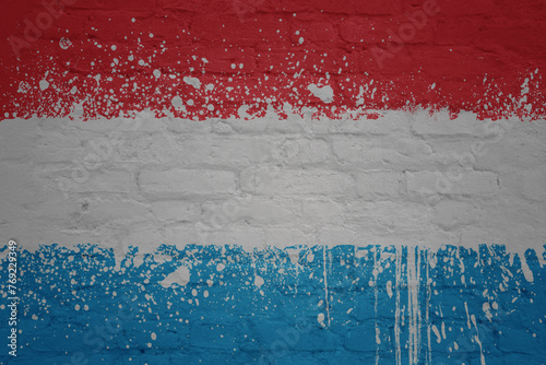 colorful painted big national flag of luxembourg on a massive brick wall