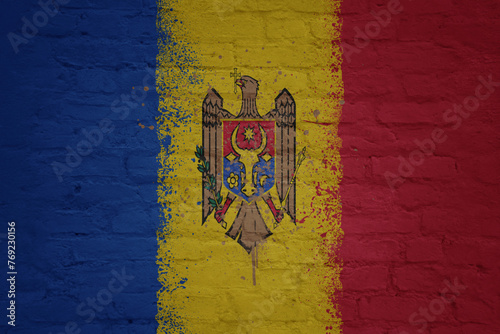 colorful painted big national flag of moldova on a massive brick wall