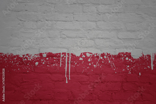 colorful painted big national flag of poland on a massive brick wall