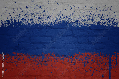 colorful painted big national flag of russia on a massive brick wall