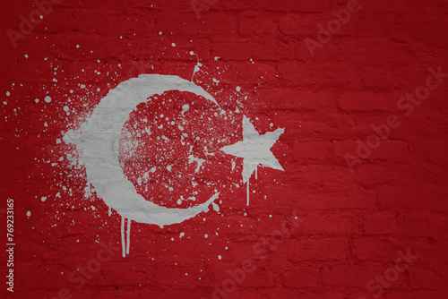 colorful painted big national flag of turkey on a massive brick wall