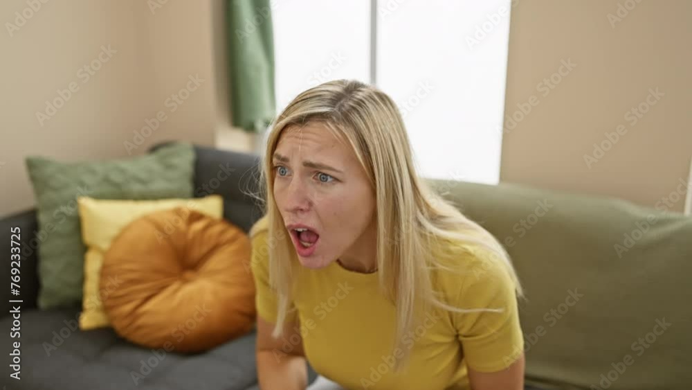 Stunned young blonde woman in t shirt showing skeptical look, sarcastic surprise painted on her face at home, utterly unconvinced and puzzled. Stunned young blonde woman in t shirt showing skeptical look, sarcastic surprise painted on her face at home, utterly unconvinced and puzzled.